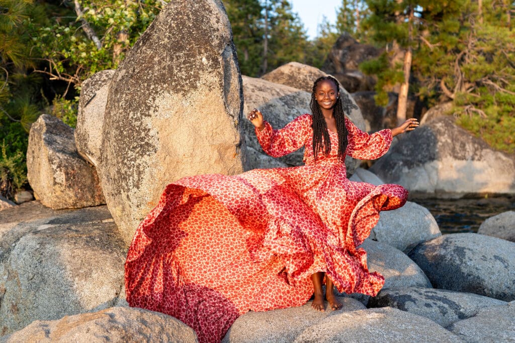 Senior girl in epic red dress at lake tahoe