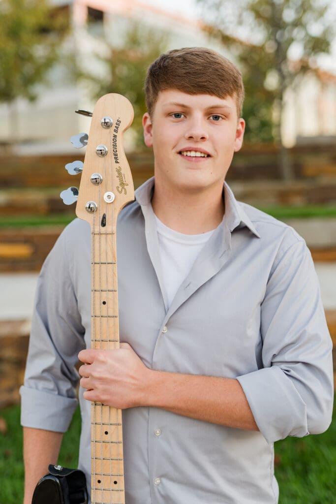 Arkansas senior with electric guitar.