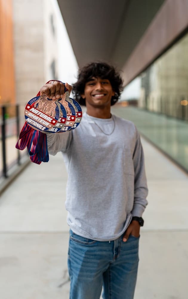 arkansas senior guy at The Ledger with weightlifting medals. 