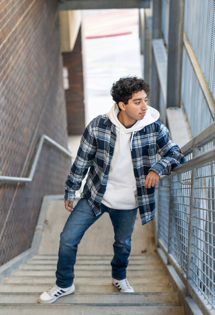 Arkansas senior guy standing on stairs in downtown Bentonville. 