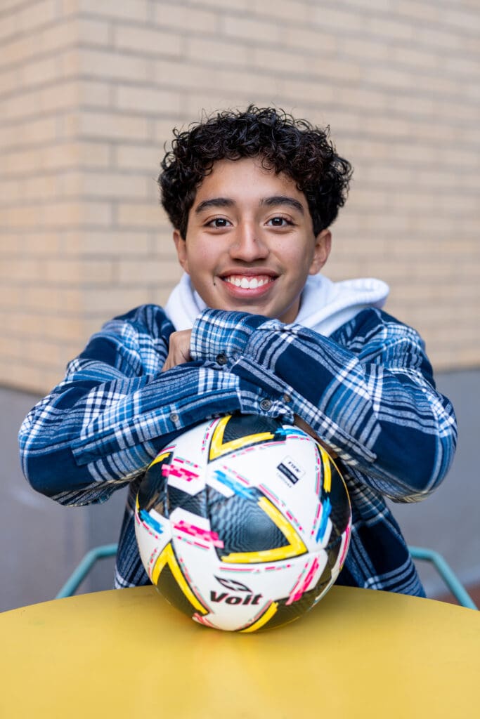 Arkansas senior guy posing with soccer ball.